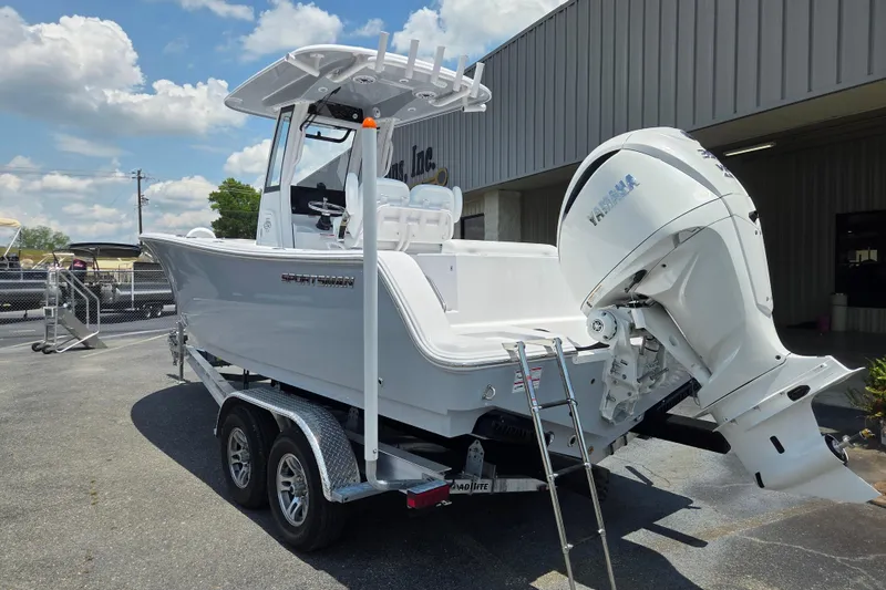 Slide: The Image of 2026 Sportsman Open 232 Center Console boat with Yamaha outboard motor on trailer. - 2