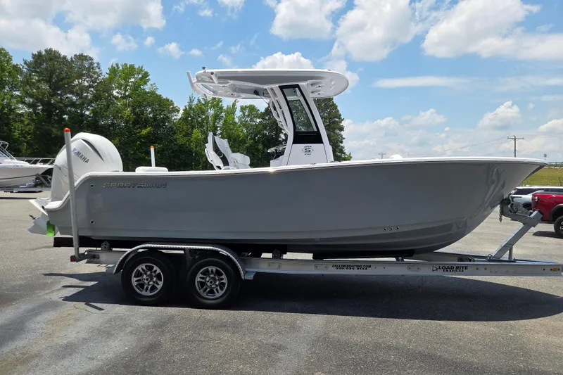 Slide: The Image of 2026 Sportsman Open 232 Center Console boat on trailer, parked outdoors. - 6