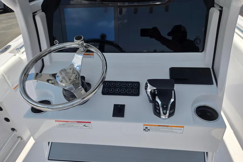 Slide: The Image of 2026 Sportsman Open 232 Center Console dashboard with steering wheel and controls. - 7