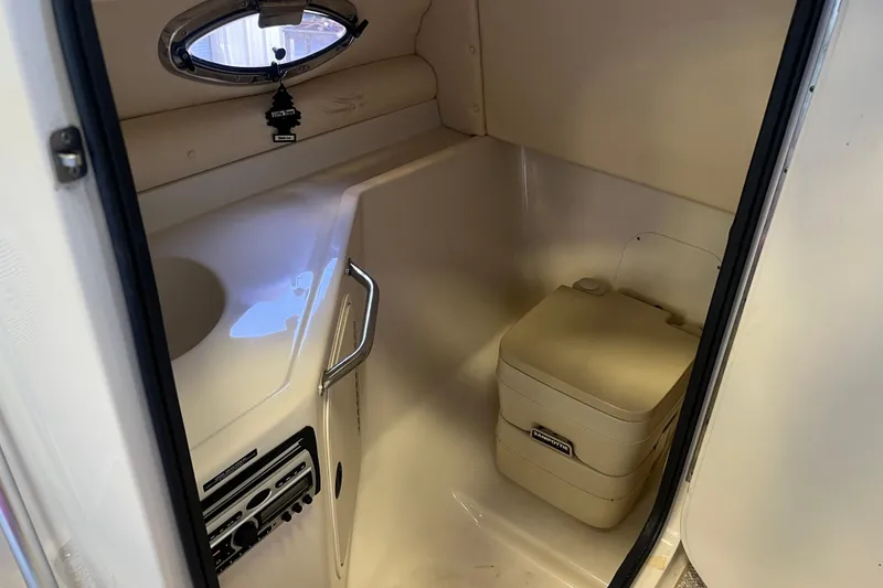 Slide: The Image of Interior of a 2004 Sea Ray 270 Sundeck boat with compact restroom facilities. - 21