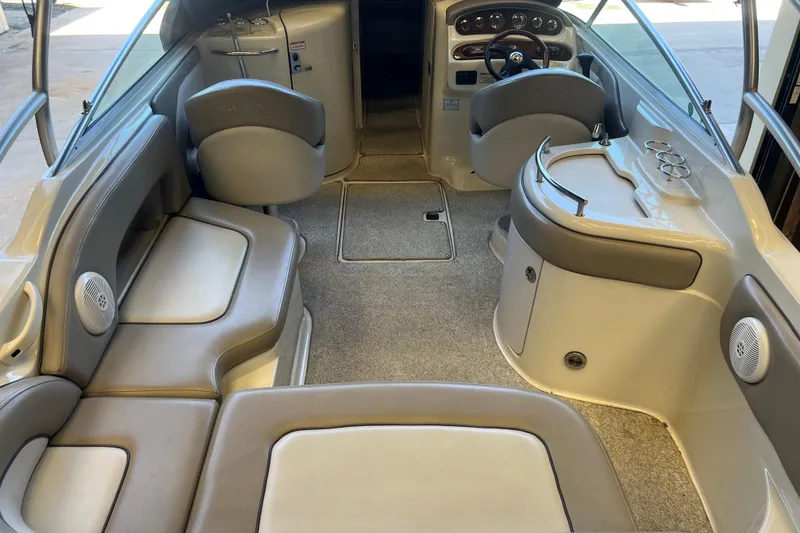 Slide: The Image of Interior of a 2004 Sea Ray 270 Sundeck boat with seating and helm. - 10