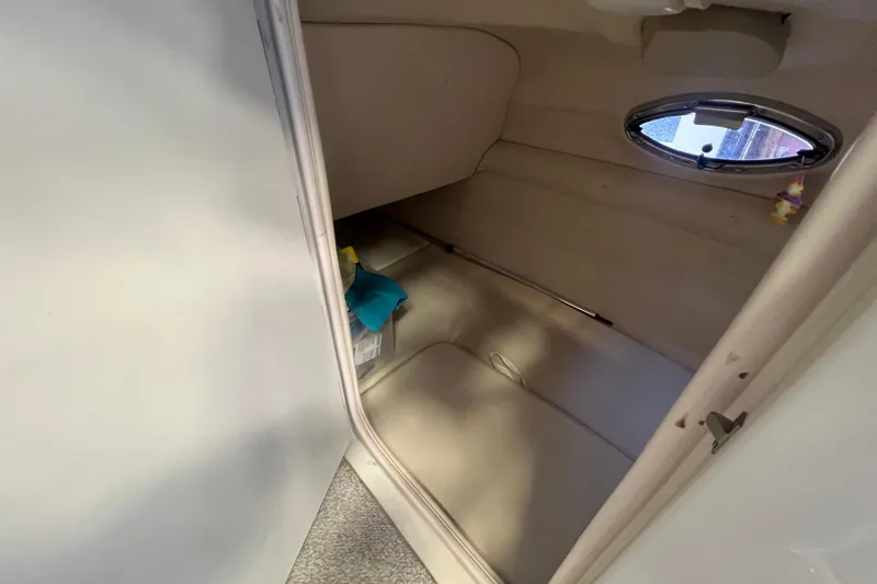 Slide: The Image of Interior cabin of 2004 Sea Ray 270 Sundeck boat with porthole window. - 22