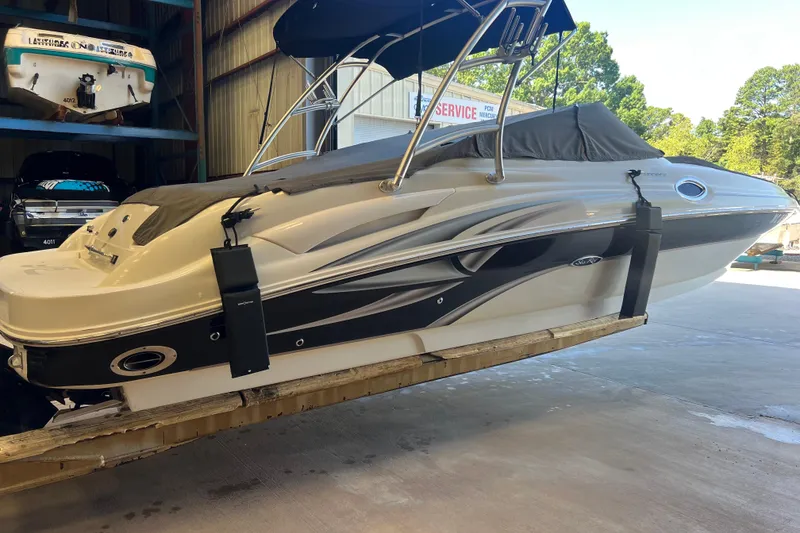 Slide: The Image of 2004 Sea Ray 270 Sundeck boat in storage, covered and elevated indoors. - 4