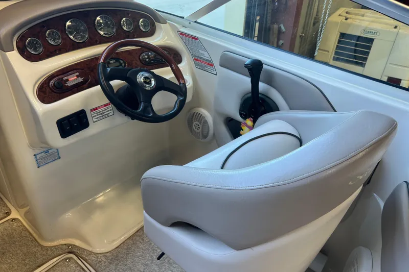 Slide: The Image of 2004 Sea Ray 270 Sundeck helm with steering wheel and control panel. - 14