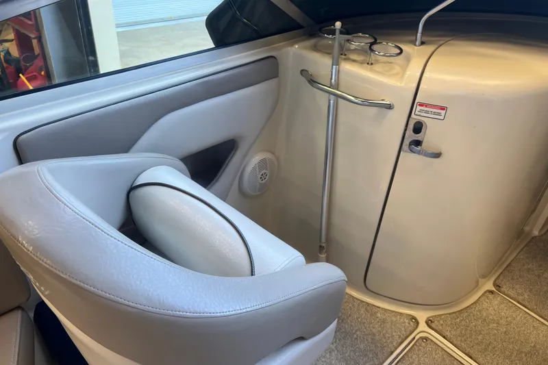 Slide: The Image of Interior of a 2004 Sea Ray 270 Sundeck boat, featuring seating and storage area. - 13