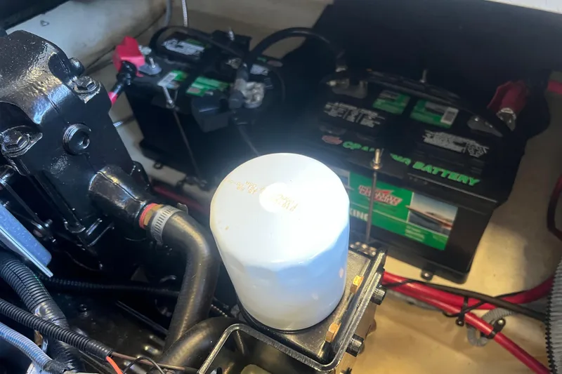 Slide: The Image of View of the engine compartment with batteries and an oil filter. - 19