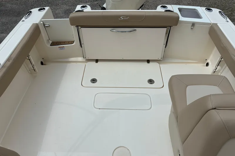 Slide: The Image of 2026 Scout 215 Dorado boat interior with beige seating and storage compartments. - 13
