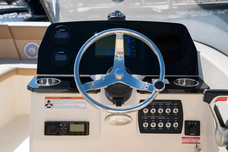 Slide: The Image of Manufacturer Provided Image: 2025 Scout 215 Dorado boat dashboard with steering wheel and control panel. - 9