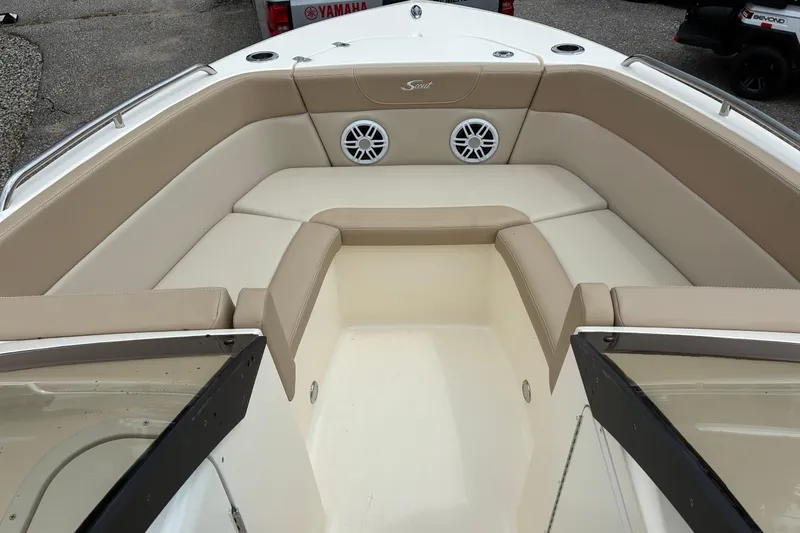 Slide: The Image of 2026 Scout 215 Dorado boat interior with beige seating and built-in speakers. - 3