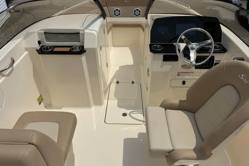 Slide: The Image of Interior view of 2026 Scout 215 Dorado boat with beige seating and modern dashboard. - 4