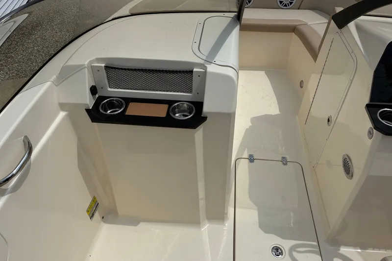 Slide: The Image of Interior view of 2026 Scout 215 Dorado boat, featuring cup holders and seating area. - 11