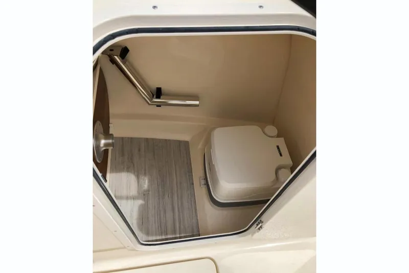Slide: The Image of Manufacturer Provided Image: 2025 Scout 215 Dorado boat interior with compact marine toilet. - 7