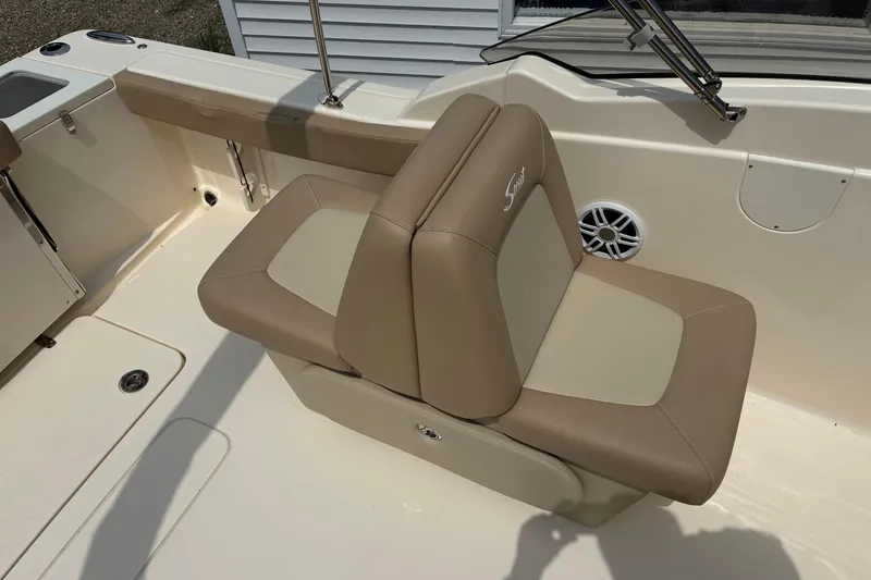 Slide: The Image of 2026 Scout 215 Dorado boat interior with beige seating and speaker detail. - 12