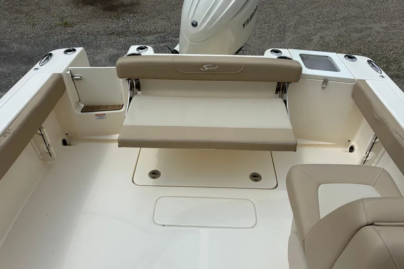 Slide: The Image of 2026 Scout 215 Dorado boat interior with beige seating and motor view. - 14