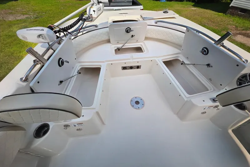 Slide: The Image of 2021 Carolina Skiff 21 Ultra Elite boat interior with open storage compartments and seating. - 3