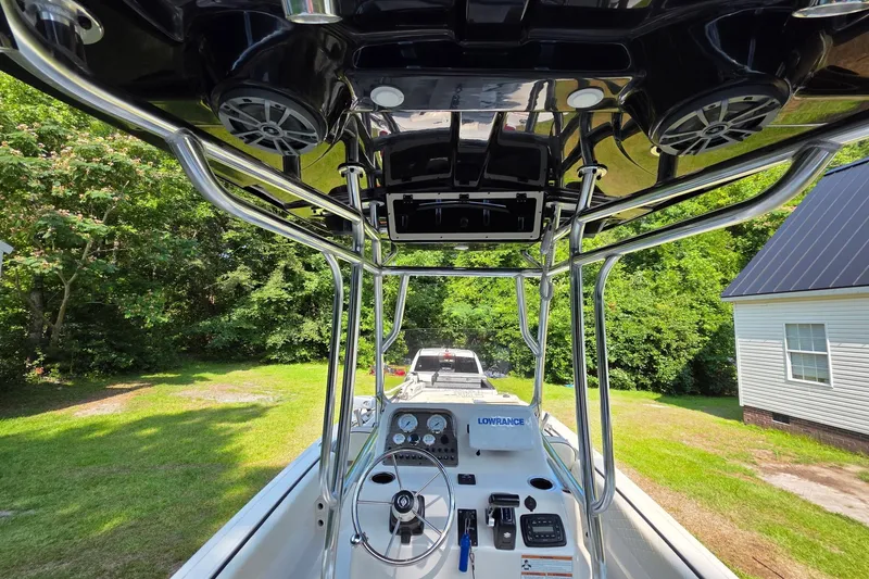 Slide: The Image of 2021 Carolina Skiff 21 Ultra Elite boat interior with steering console and canopy. - 5
