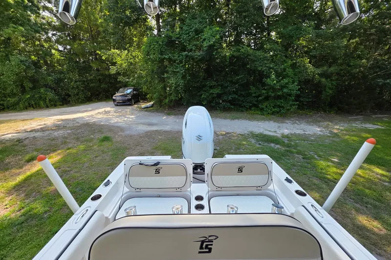 Slide: The Image of 2021 Carolina Skiff 21 Ultra Elite boat parked near a wooded area. - 6