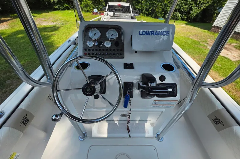 Slide: The Image of 2021 Carolina Skiff 21 Ultra Elite boat console with steering wheel and navigation equipment. - 4