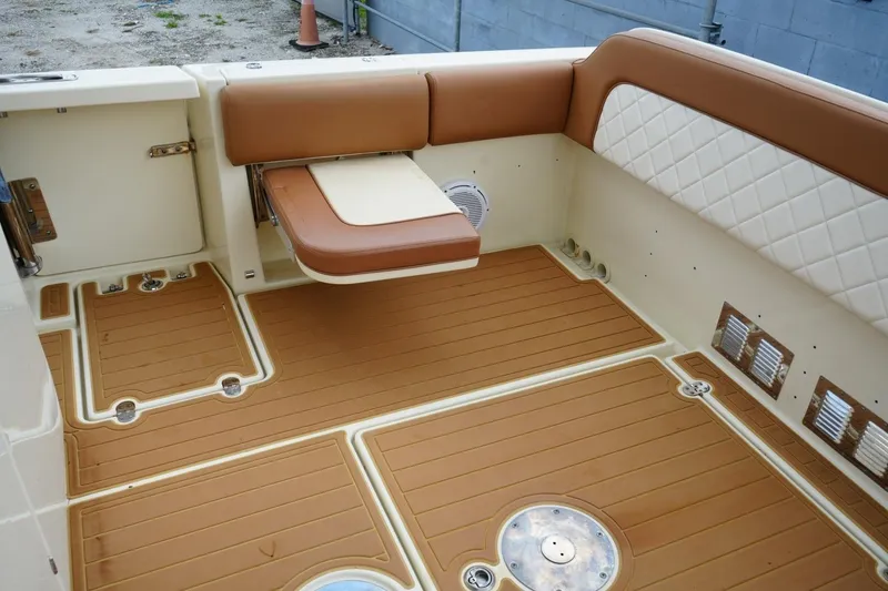 Slide: The Image of 2016 Chris-Craft Catalina 34 interior with tan seating and teak-style flooring. - 48