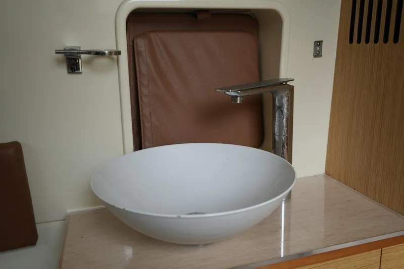 Slide: The Image of White sink and modern faucet in 2016 Chris-Craft Catalina 34 boat interior. - 35