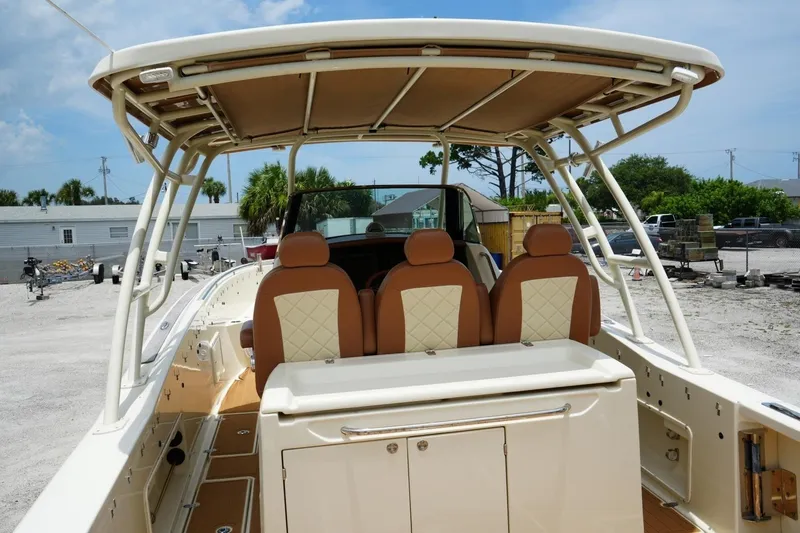 Slide: The Image of 2016 Chris-Craft Catalina 34 boat interior with tan seating and canopy. - 15