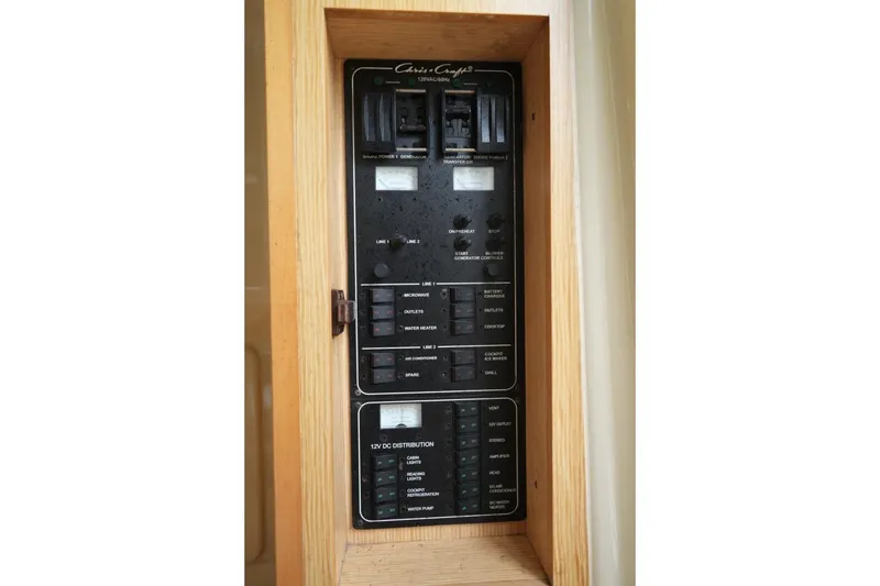 Slide: The Image of Electrical panel of 2016 Chris-Craft Catalina 34 boat, featuring various switches and controls. - 33