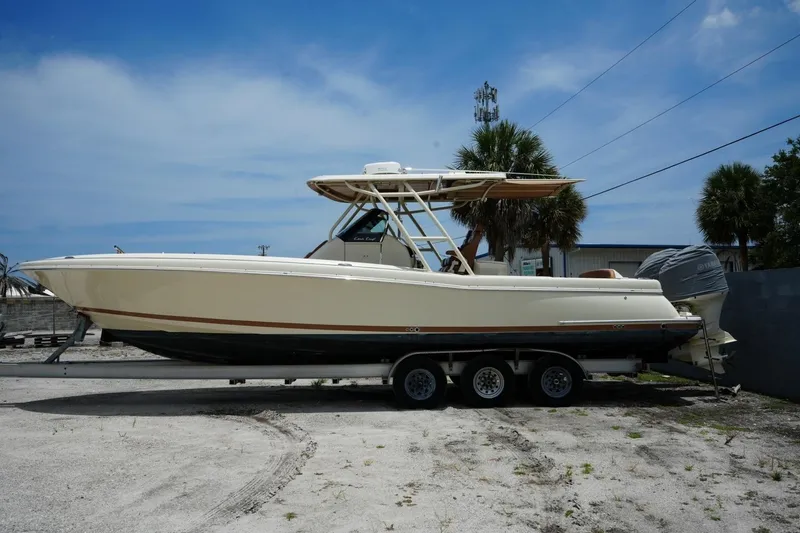 Slide: The Image of 2016 Chris-Craft Catalina 34 boat on trailer, parked outdoors under blue sky. - 2