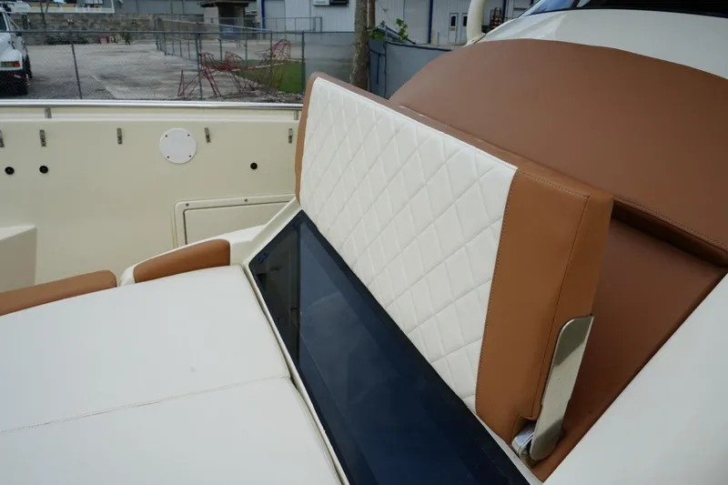 Slide: The Image of 2016 Chris-Craft Catalina 34 boat interior with tan and white quilted seating. - 31