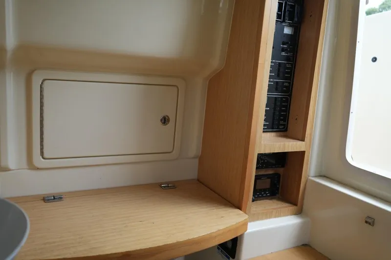 Slide: The Image of Interior view of 2016 Chris-Craft Catalina 34, featuring wooden cabinetry and control panels. - 37