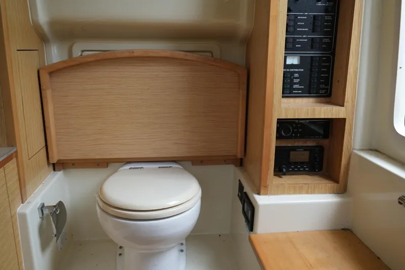 Slide: The Image of 2016 Chris-Craft Catalina 34 boat interior with toilet and control panel. - 36