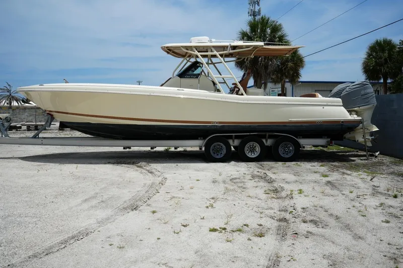 Slide: The Image of 2016 Chris-Craft Catalina 34 boat on trailer, parked outdoors under clear sky. - 3