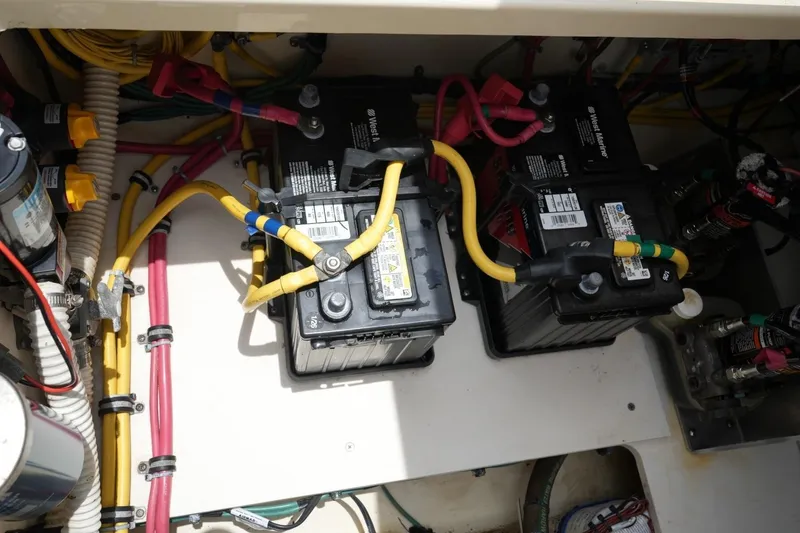 Slide: The Image of Battery compartment of a 2016 Chris-Craft Catalina 34, featuring wiring and connections. - 53