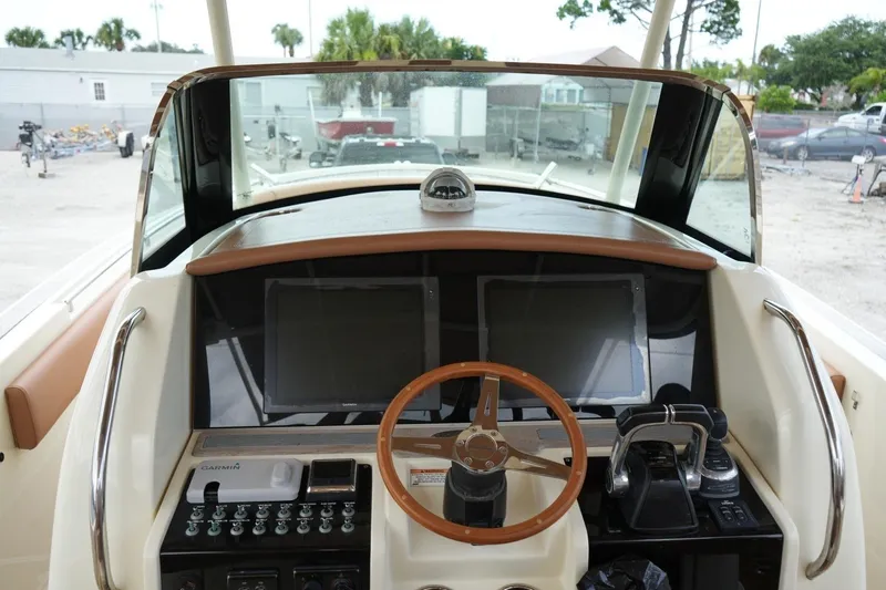 Slide: The Image of 2016 Chris-Craft Catalina 34 helm with dual screens and wooden steering wheel. - 40