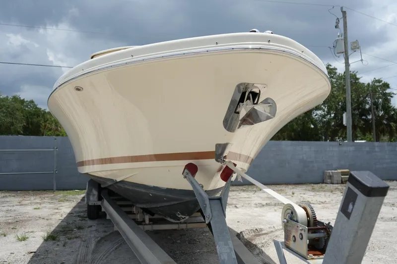 Slide: The Image of 2016 Chris-Craft Catalina 34 boat on trailer, viewed from the front, under cloudy sky. - 8