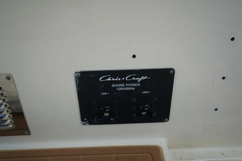 Slide: The Image of Chris-Craft Catalina 34 2016 shore power panel, 120V/60Hz, dual line switches. - 44