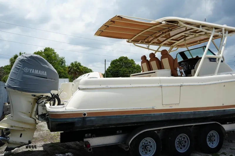 Slide: The Image of 2016 Chris-Craft Catalina 34 boat with Yamaha engine on trailer, under cloudy sky. - 12