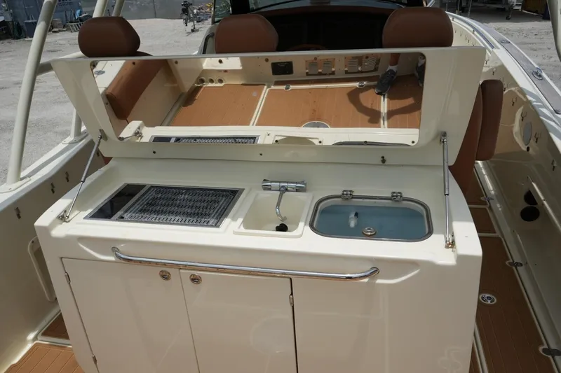 Slide: The Image of 2016 Chris-Craft Catalina 34 boat interior with kitchenette and seating area. - 18