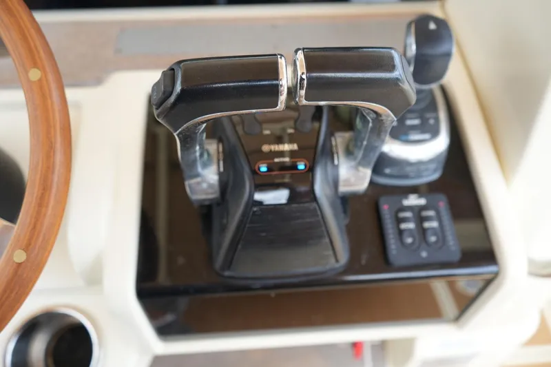 Slide: The Image of Close-up of 2016 Chris-Craft Catalina 34 throttle controls and steering wheel. - 23