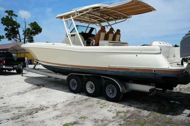Slide: The Image of 2016 Chris-Craft Catalina 34 boat on trailer, parked outdoors under clear sky. - 5