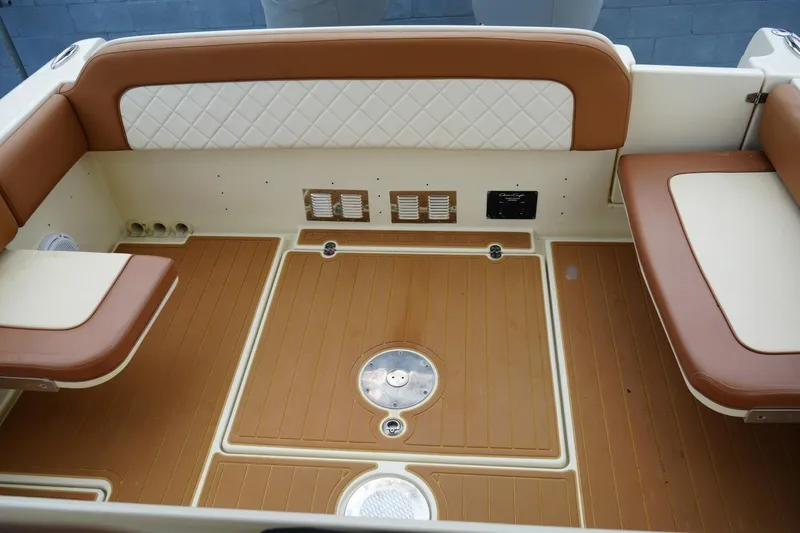 Slide: The Image of 2016 Chris-Craft Catalina 34 boat interior with tan and white seating and teak flooring. - 49