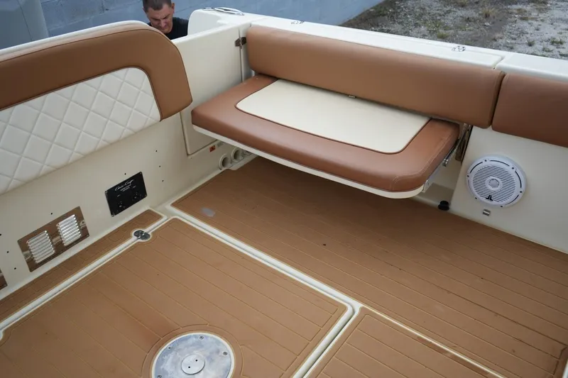 Slide: The Image of 2016 Chris-Craft Catalina 34 boat interior with tan seating and speaker. - 47