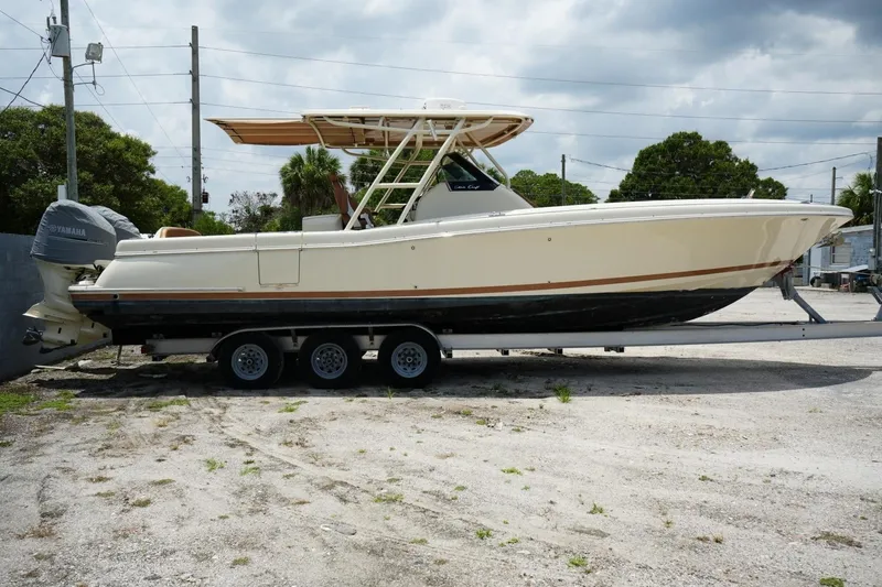 Slide: The Image of 2016 Chris-Craft Catalina 34 boat on trailer, side view, outdoors under cloudy sky. - 4