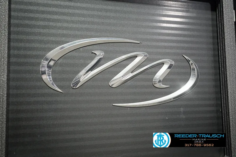 Slide: The Image of Chrome logo of 2018 Manitou 23 Oasis RF VP on textured black surface. - 66