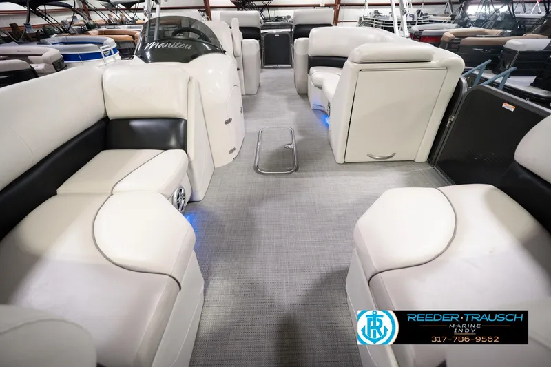 Slide: The Image of 2018 Manitou 23 Oasis RF VP pontoon boat interior with plush seating and modern design. - 18