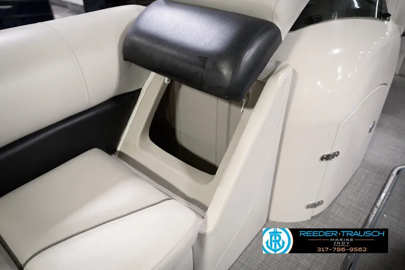 Slide: The Image of 2018 Manitou 23 Oasis RF VP boat seat with storage compartment open. - 29