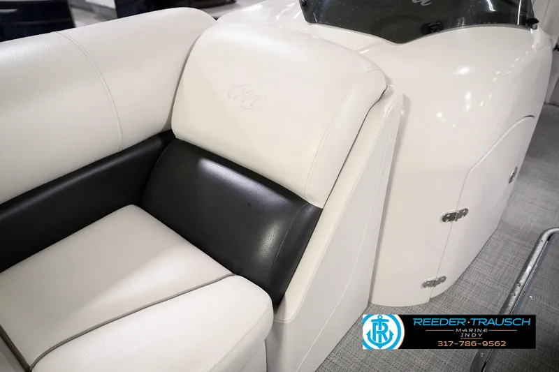 Slide: The Image of 2018 Manitou 23 Oasis RF VP boat interior with white and black seating. - 28