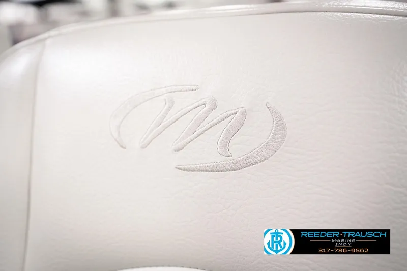 Slide: The Image of White leather seat with Manitou logo, 2018 Manitou 23 Oasis RF VP. Reeder-Trausch Marine contact info. - 55