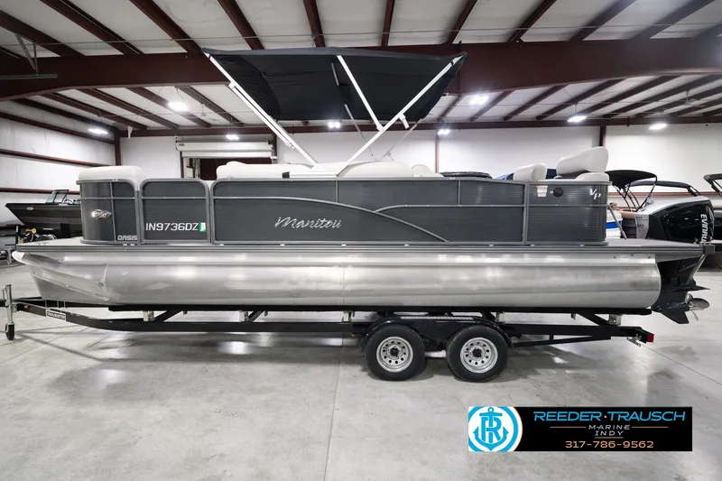 Slide: The Image of 2018 Manitou 23 Oasis RF VP pontoon boat on trailer in indoor showroom. - 12