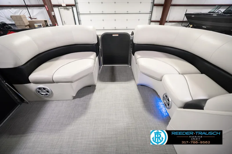 Slide: The Image of 2018 Manitou 23 Oasis RF VP pontoon boat interior with plush seating and modern design. - 25