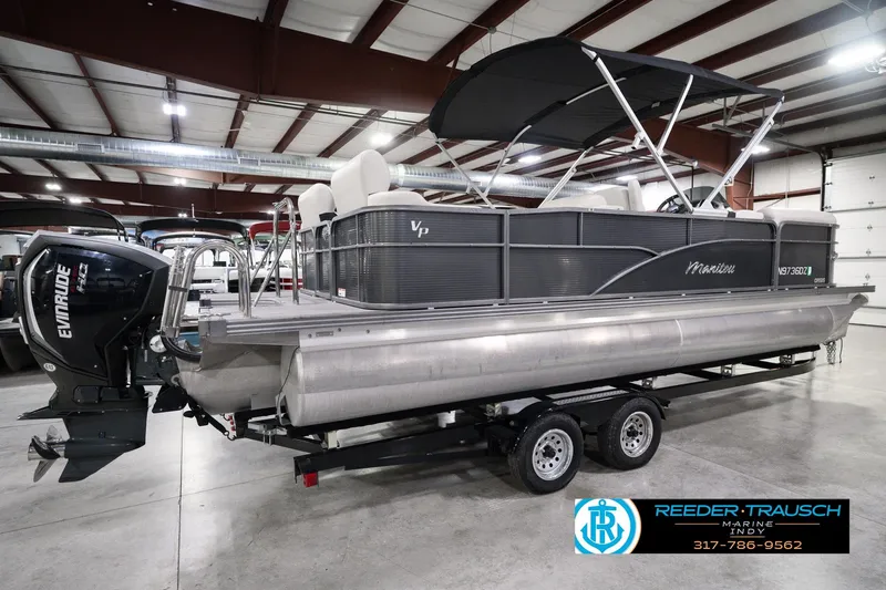 Slide: The Image of 2018 Manitou 23 Oasis RF VP pontoon boat with Evinrude engine in indoor showroom. - 8